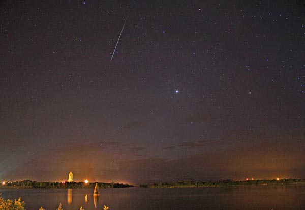 This early morning skyscape was captured last week on August 4th, looking northeast across calm waters in the Turn Basin at NASA's Kennedy Space Center. In a striking contrast in motion, the space shuttle Discovery, mounted on a massive transporter, creeps toward launch pad 39A at less than two miles per hour, while a brilliant meteor streaks through the sky traveling many miles per second. Of course, this week skywatchers have seen many similar meteor streaks during the annual Perseid meteor shower. But the meteor flashing above Discovery is not likely to be one of the Perseids because its path doesn't point back to that shower's radiant. Seen here near picture center, brilliant planet Venus still dominates the sky as the Morning Star, though. Yellowish tinted Mars lies near the top of the frame and Orion's red giant star Betelgeuse is toward the right.  (http://www.nasa.gov)